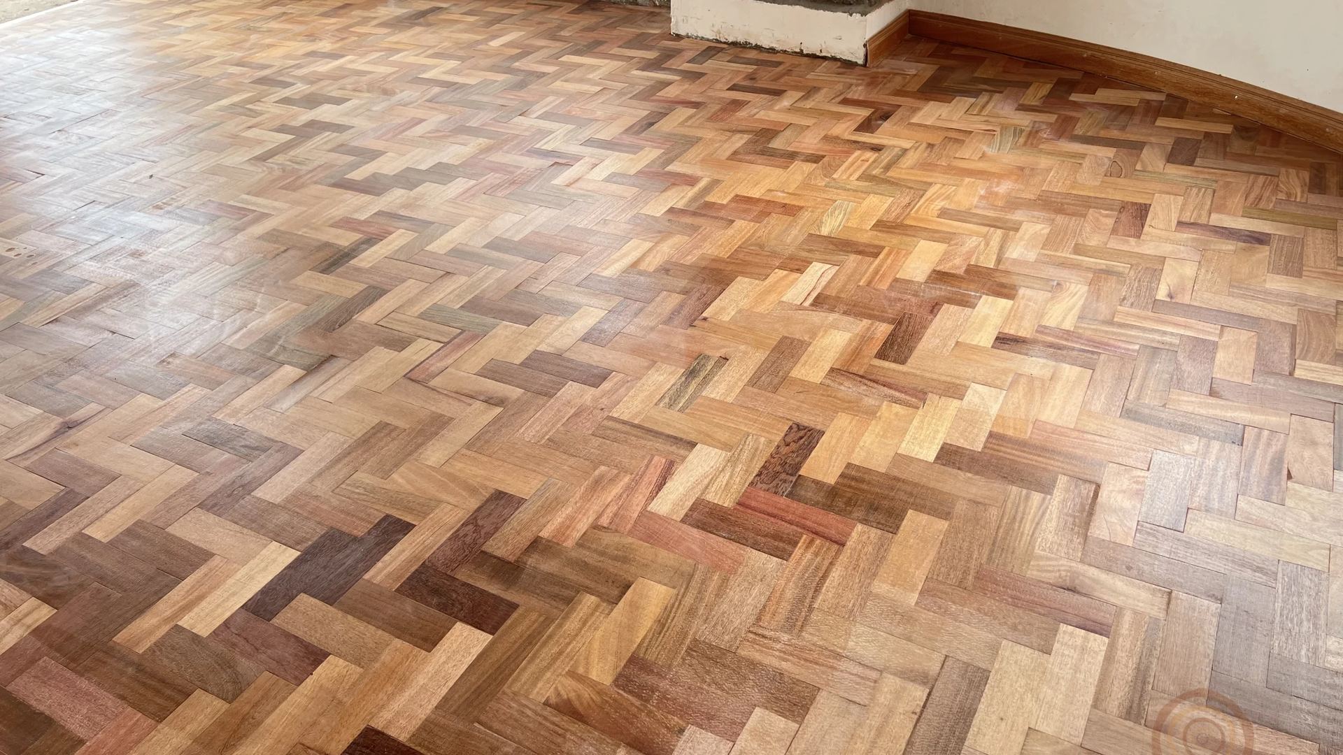 Parquet and mahogany floors with a warm, polished finish.